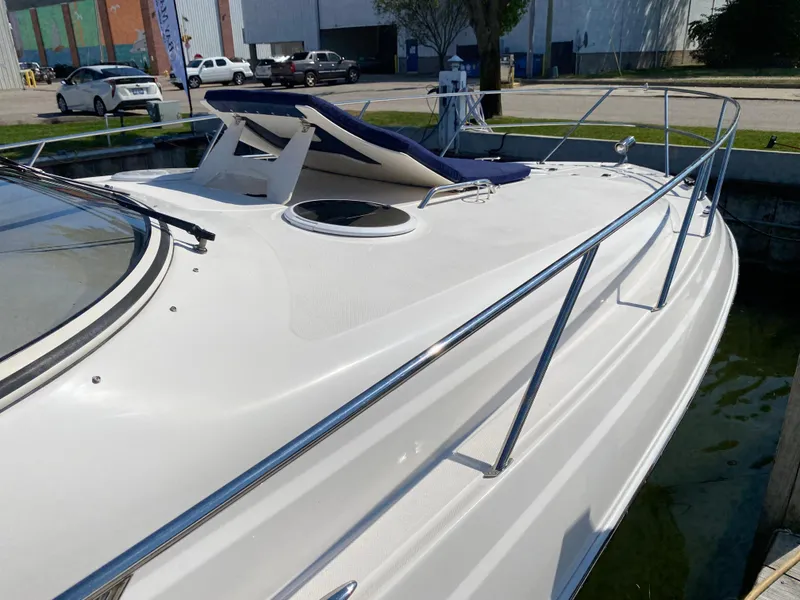Slide: The Image of 2006 Regal 3560 Commodore yacht with sleek deck and sunbed in marina. - 9
