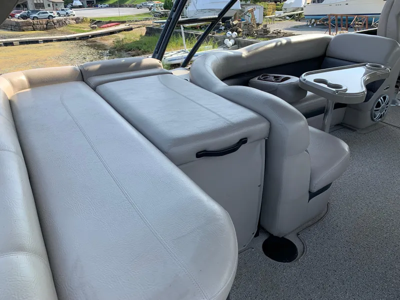 Slide: The Image of 2013 Premier 310 Boundary Waters Sky Dek interior with plush seating and table. - 12