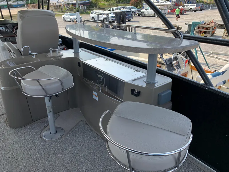 Slide: The Image of 2013 Premier 310 Boundary Waters Sky Dek interior with seating and bar area. - 13