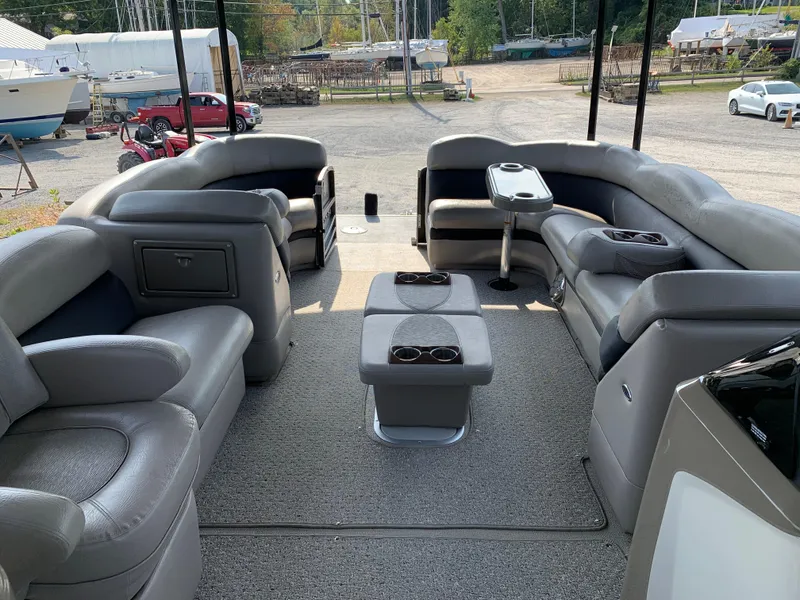 Slide: The Image of 2013 Premier 310 Boundary Waters Sky Dek pontoon boat interior with gray seating and table. - 17