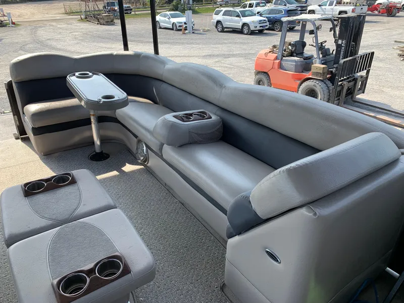 Slide: The Image of 2013 Premier 310 Boundary Waters Sky Dek boat interior with gray seating and cup holders. - 24