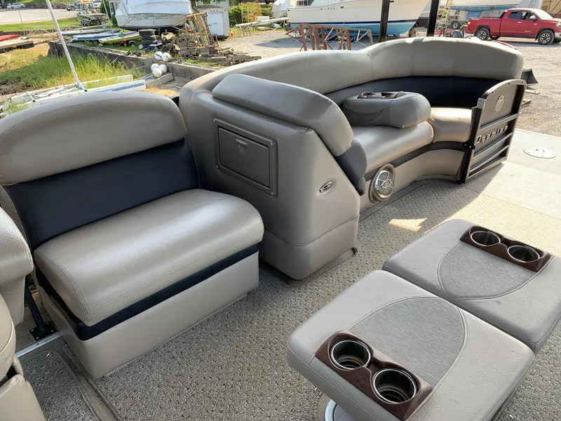 Slide: The Image of 2013 Premier 310 Boundary Waters Sky Dek boat interior with gray seating and cup holders. - 25
