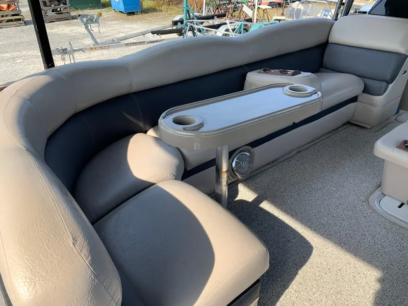 Slide: The Image of 2013 Premier 310 Boundary Waters Sky Dek boat interior with beige seating and cup holders. - 26