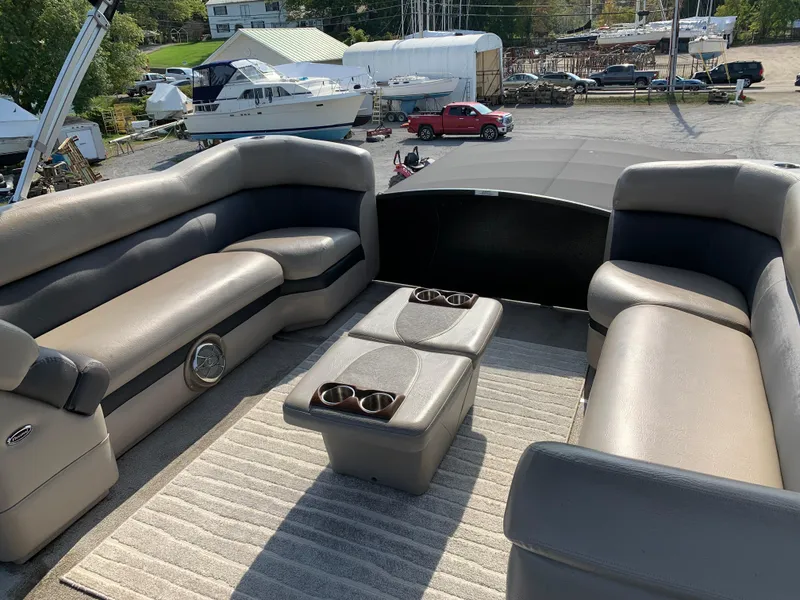 Slide: The Image of 2013 Premier 310 Boundary Waters Sky Dek interior with plush seating and cup holders. - 30