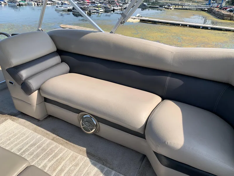 Slide: The Image of 2013 Premier 310 Boundary Waters Sky Dek boat interior with beige seating by the water. - 35