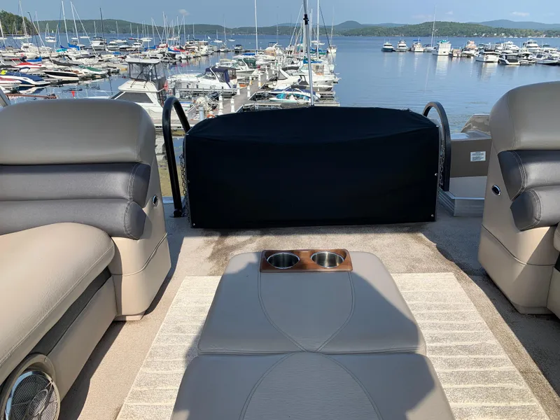 Slide: The Image of Premier 310 Boundary Waters Sky Dek 2013 on lake, surrounded by boats and scenic view. - 36