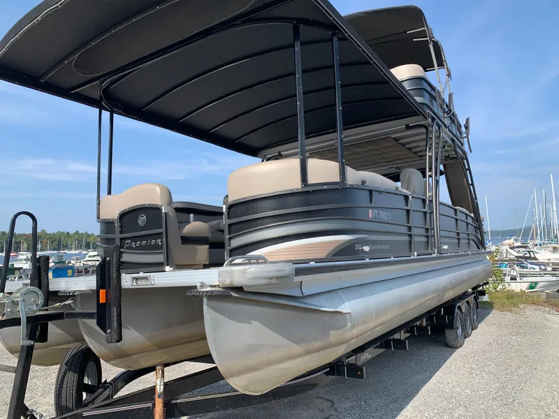 Slide: The Image of 2013 Premier 310 Boundary Waters Sky Dek pontoon boat on trailer at marina. - 6