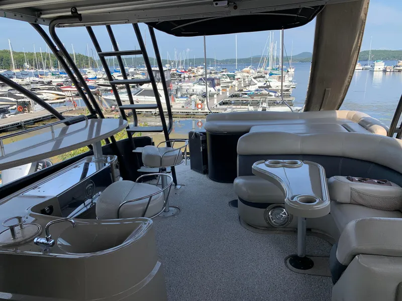 Slide: The Image of Luxurious 2013 Premier 310 Boundary Waters Sky Dek pontoon boat interior at marina. - 9