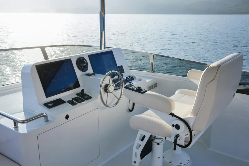 Slide: The Image of Helm of 2024 CL Yachts CLB65 with modern controls and ocean view. - 11