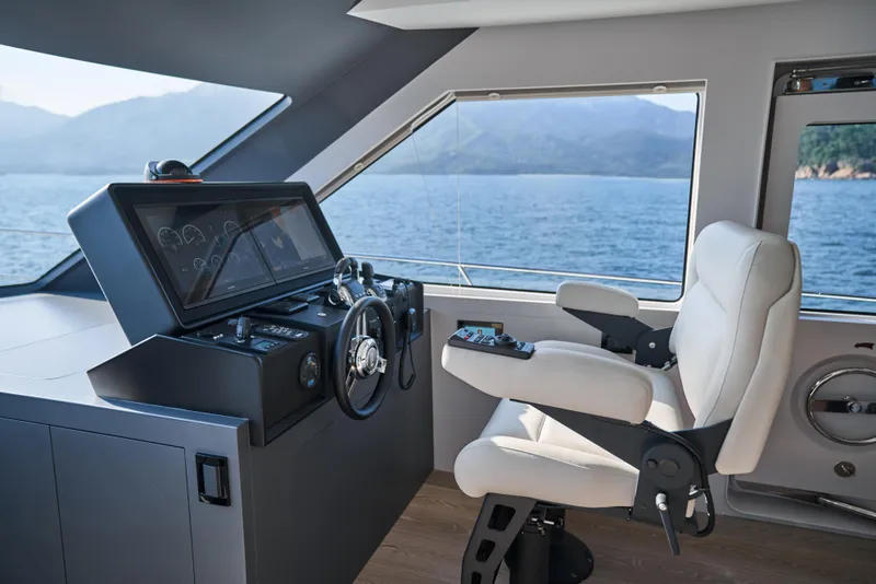 Slide: The Image of 2024 CL Yachts CLB65 helm station with modern controls and panoramic sea view. - 19