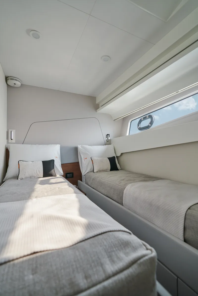 Slide: The Image of 2024 CL Yachts CLB65 cabin with twin beds and modern interior design. - 28