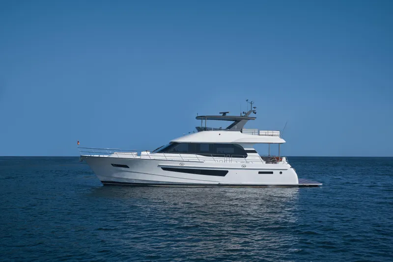 Slide: The Image of 2024 CL Yachts CLB65 luxury yacht cruising on open sea under clear blue sky. - 1