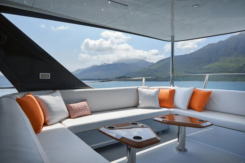 Slide: The Image of Luxurious 2024 CL Yachts CLB65 yacht deck with elegant seating and scenic ocean view. - 12