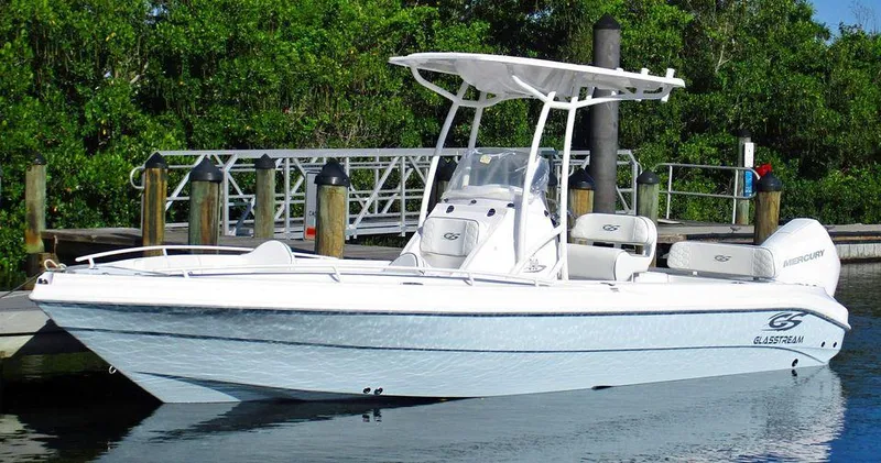 The Image of 2024 Glasstream 240 CCX boat docked by lush greenery. - 1