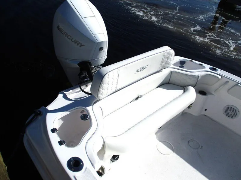 Slide: The Image of 2024 Glasstream 240 CCX boat with Mercury engine, featuring white seating and cup holders. - 4