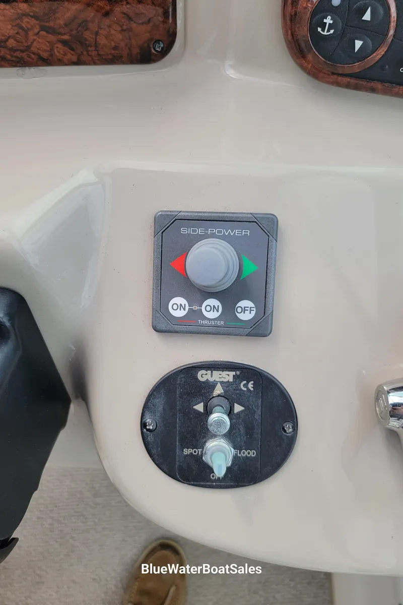 Slide: The Image of Control panel of a 2006 Sea Ray 320 Sundancer boat with various switches. - 14