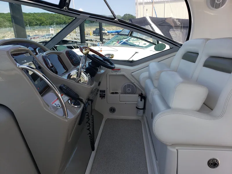 Slide: The Image of Interior cockpit of 2006 Sea Ray 320 Sundancer with helm controls and seating. - 22
