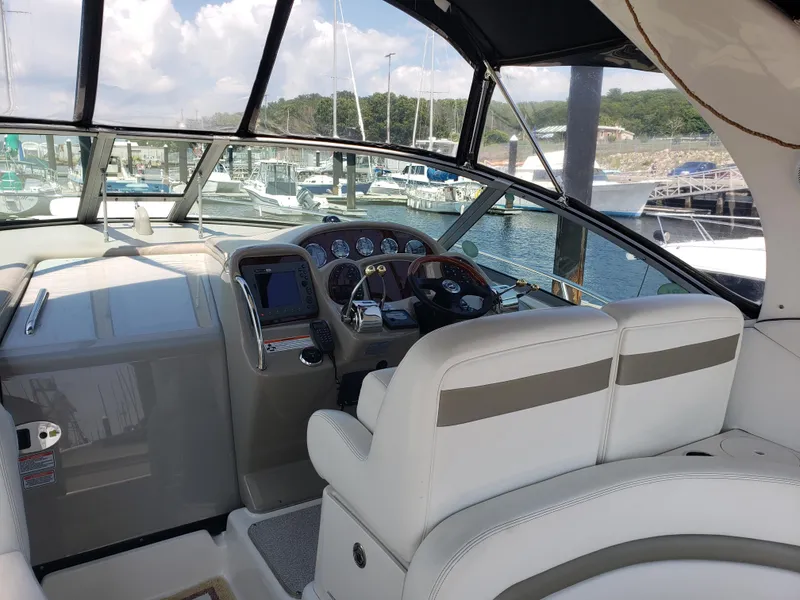 Slide: The Image of Interior view of 2006 Sea Ray 320 Sundancer boat cockpit with steering wheel and controls. - 24