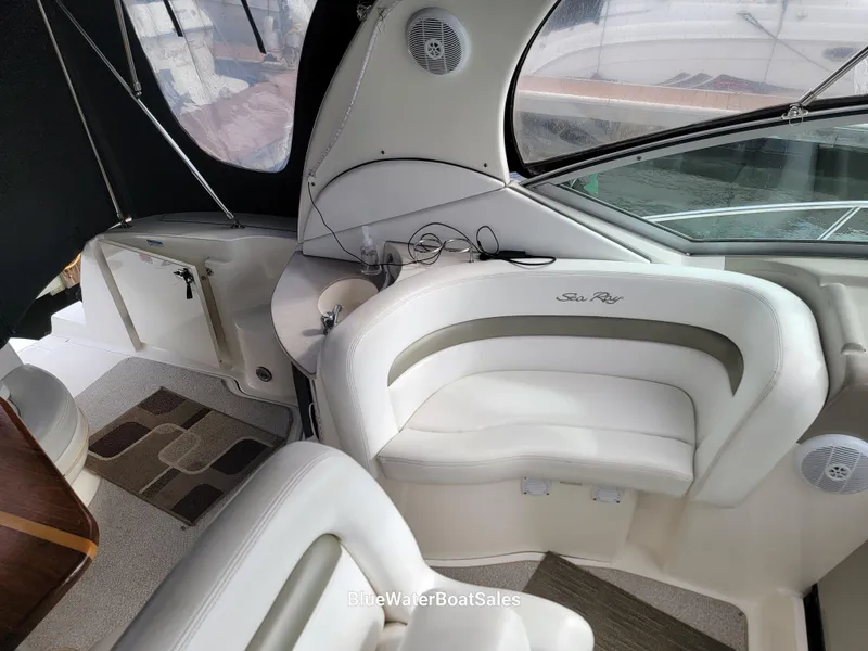 Slide: The Image of 2006 Sea Ray 320 Sundancer interior with white seating and modern design. - 27
