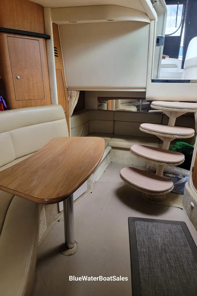 Slide: The Image of Interior of 2006 Sea Ray 320 Sundancer with seating and wooden table. - 30