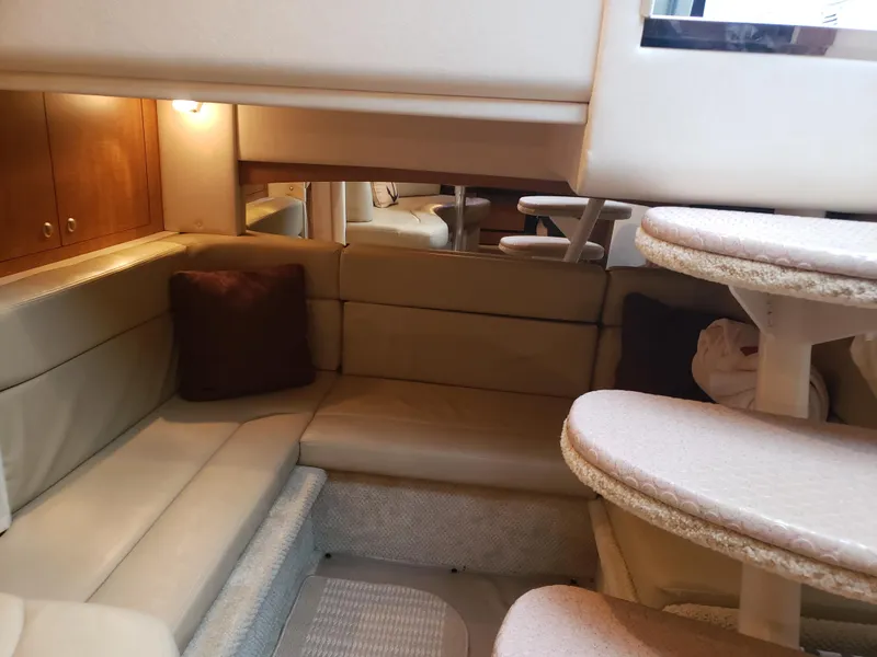 Slide: The Image of Interior of 2006 Sea Ray 320 Sundancer with beige seating and wooden accents. - 31