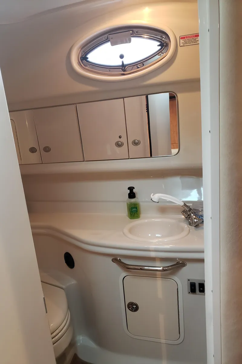 Slide: The Image of 2006 Sea Ray 320 Sundancer bathroom with sink, mirror, and storage cabinets. - 34