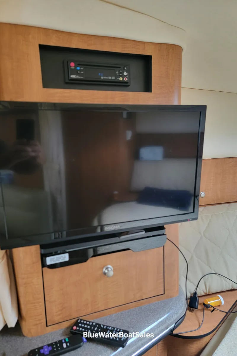 Slide: The Image of Interior of 2006 Sea Ray 320 Sundancer with mounted TV and entertainment system. - 36