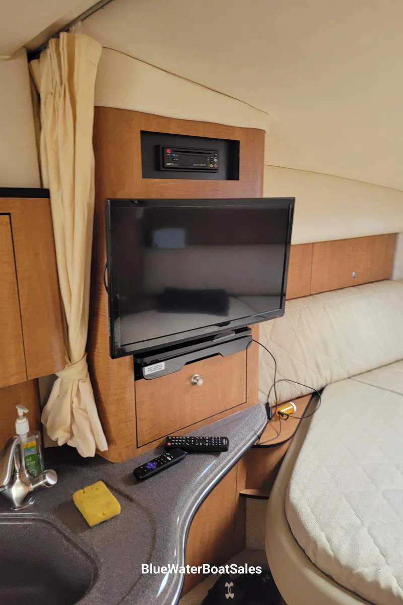 Slide: The Image of Interior of 2006 Sea Ray 320 Sundancer with TV, bed, and sink area. - 38