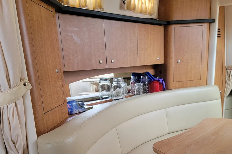 Slide: The Image of Interior of 2006 Sea Ray 320 Sundancer with wooden cabinets and seating area. - 39