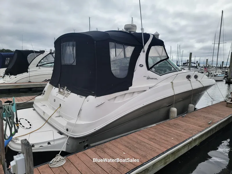 Slide: The Image of 2006 Sea Ray 320 Sundancer docked at marina with black canopy. - 4