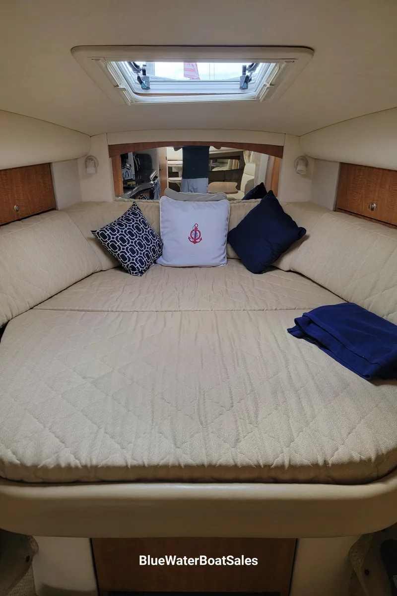 Slide: The Image of 2006 Sea Ray 320 Sundancer cabin with cozy bedding and decorative pillows. - 41