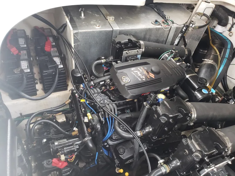 Slide: The Image of Engine compartment of a 2006 Sea Ray 320 Sundancer, showcasing mechanical components and wiring. - 42