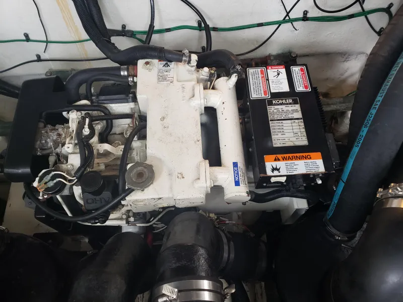 Slide: The Image of Engine compartment of a 2006 Sea Ray 320 Sundancer with Kohler generator. - 44