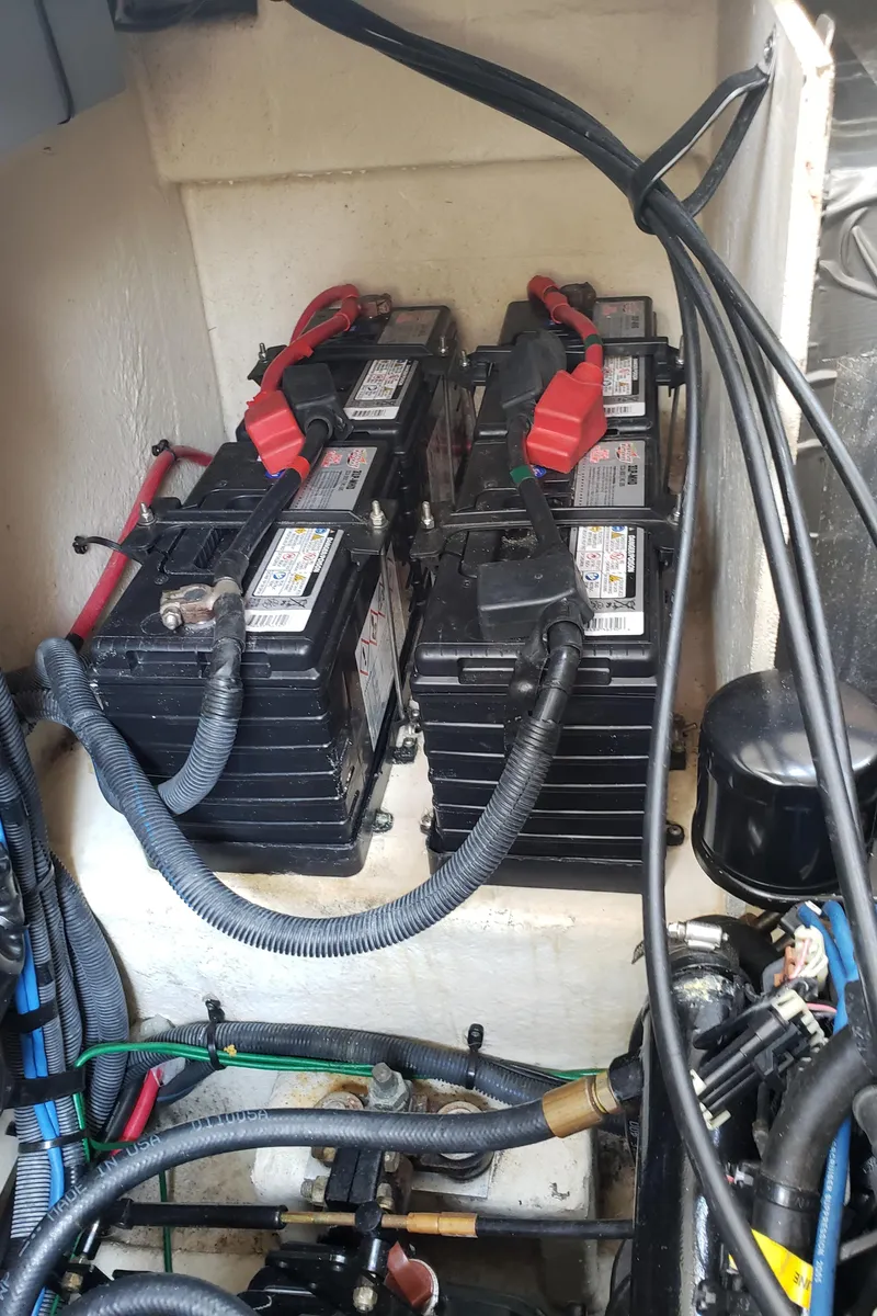 Slide: The Image of Battery compartment of a 2006 Sea Ray 320 Sundancer boat with multiple batteries and cables. - 45