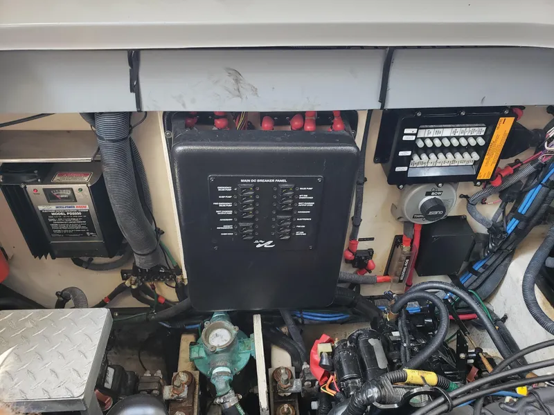 Slide: The Image of Engine compartment of a 2006 Sea Ray 320 Sundancer with electrical components and wiring. - 47