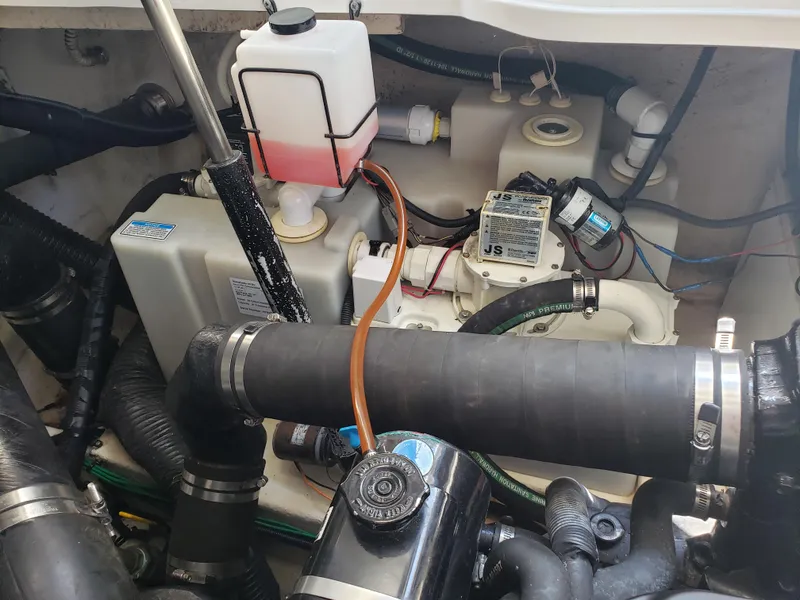 Slide: The Image of Engine compartment of a 2006 Sea Ray 320 Sundancer with visible components and hoses. - 48