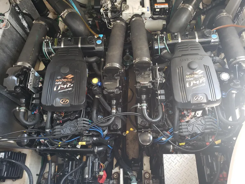 Slide: The Image of Twin engines of a 2006 Sea Ray 320 Sundancer boat, showcasing detailed mechanical components. - 49