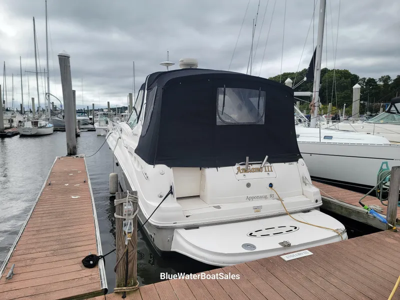 Slide: The Image of 2006 Sea Ray 320 Sundancer docked at marina with black canvas cover. - 5
