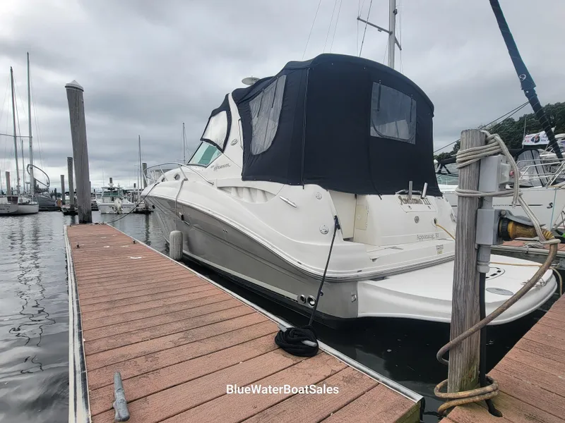 Slide: The Image of 2006 Sea Ray 320 Sundancer docked at marina under cloudy skies. - 6
