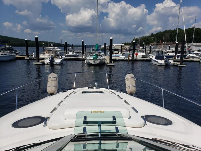 Slide: The Image of 2006 Sea Ray 320 Sundancer docked at marina under blue sky with clouds. - 7
