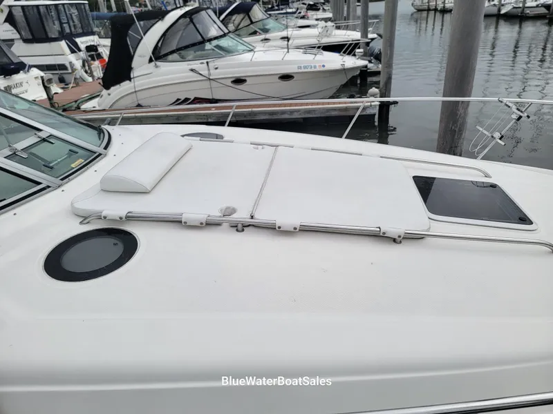 Slide: The Image of 2006 Sea Ray 320 Sundancer yacht docked at marina, featuring spacious deck and sleek design. - 9