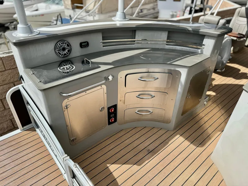 Slide: The Image of 2019 Premier Accolade 310 boat kitchen with stove, storage, and wood flooring. - 14