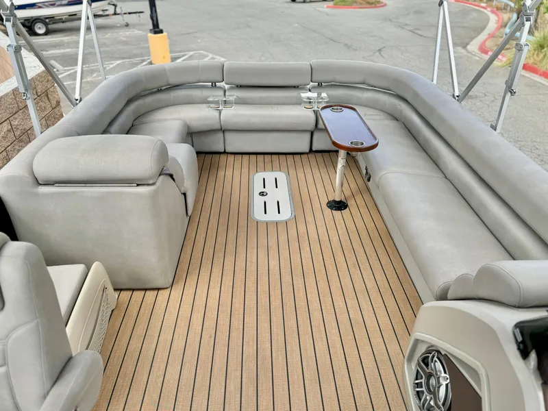 Slide: The Image of 2019 Premier Accolade 310 boat interior with gray seating and wood flooring. - 23