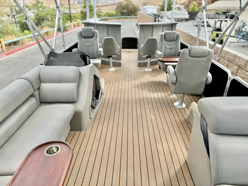 Slide: The Image of 2019 Premier Accolade 310 boat interior with plush seating and wood-style flooring. - 24
