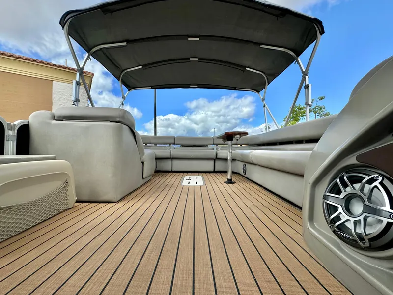 Slide: The Image of 2019 Premier Accolade 310 pontoon boat interior with canopy and seating. - 27