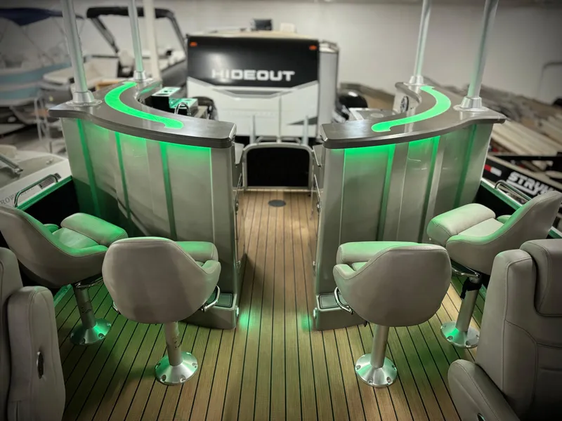 Slide: The Image of Luxurious 2019 Premier Accolade 310 boat interior with green LED lighting and plush seating. - 39