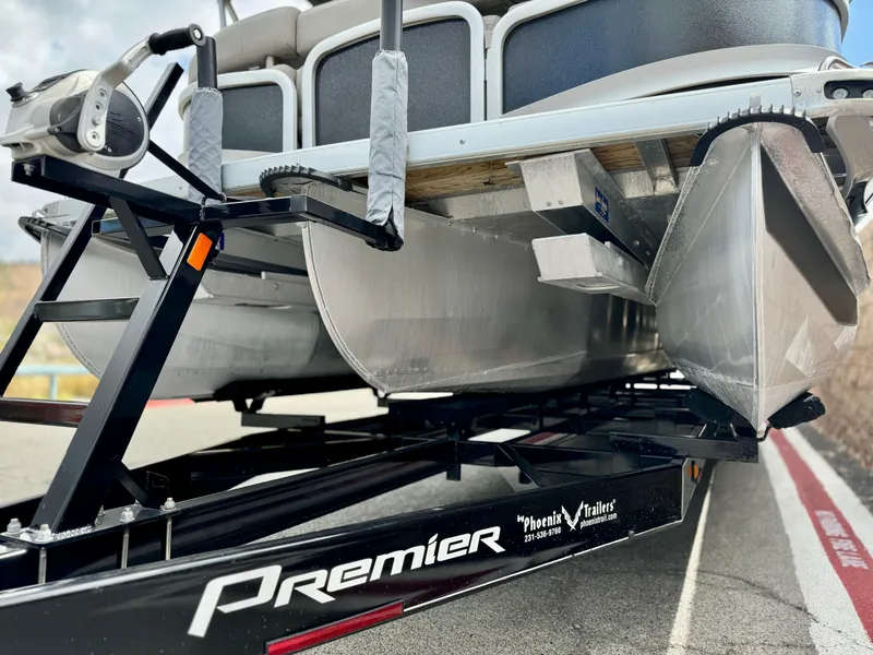 Slide: The Image of 2019 Premier Accolade 310 pontoon boat on trailer, close-up view. - 4