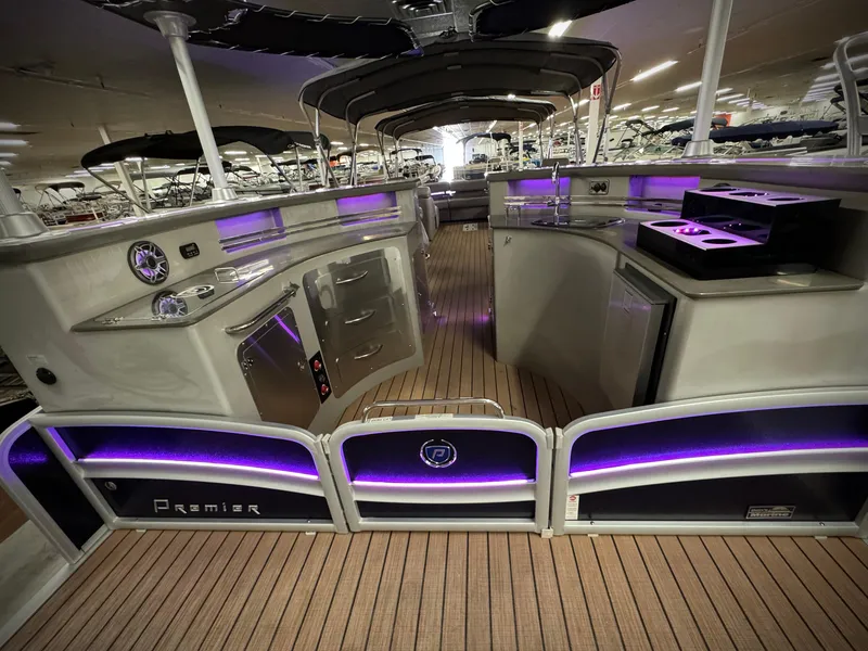 Slide: The Image of 2019 Premier Accolade 310 boat interior with purple LED lighting and modern amenities. - 43