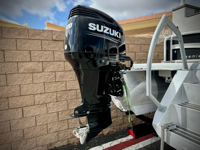 Slide: The Image of Suzuki outboard motor on 2019 Premier Accolade 310 boat, parked by brick wall. - 7