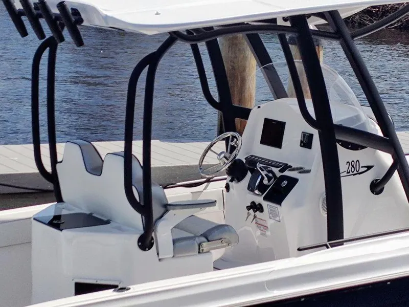 Slide: The Image of 2024 Glasstream 280 Pro-XS boat interior with steering console and seating. - 3